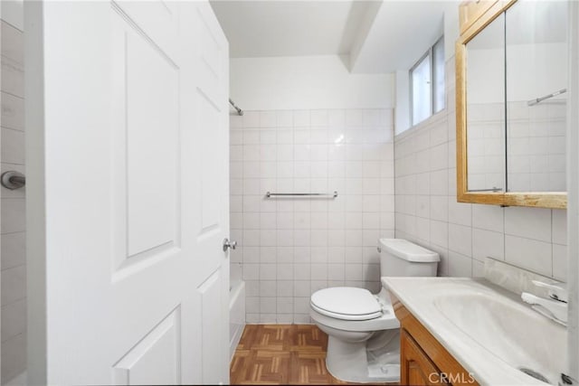 full bathroom featuring toilet, vanity, tile walls, and  shower combination