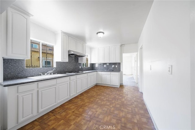 kitchen featuring sink and white cabinetry