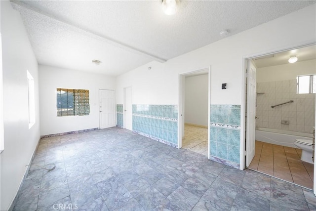 spare room with a textured ceiling