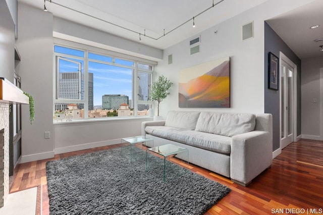 living room featuring hardwood / wood-style flooring and rail lighting