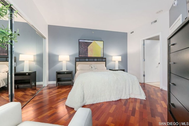 bedroom featuring wood-type flooring and a closet