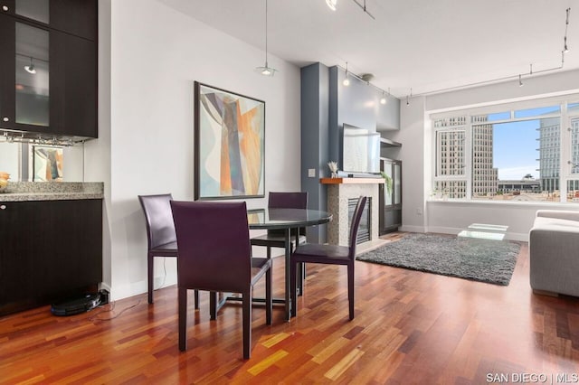 dining room featuring hardwood / wood-style flooring and rail lighting