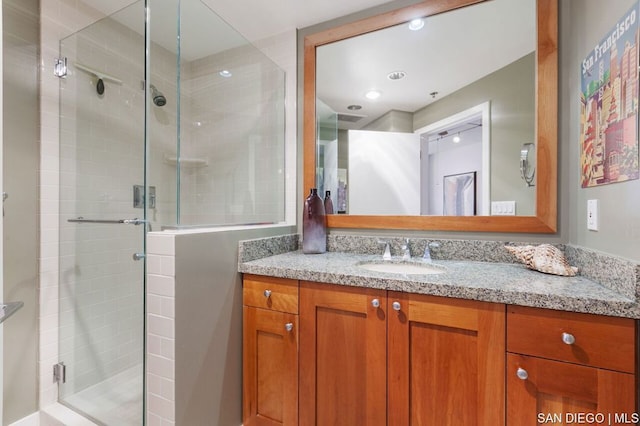 bathroom featuring an enclosed shower and vanity