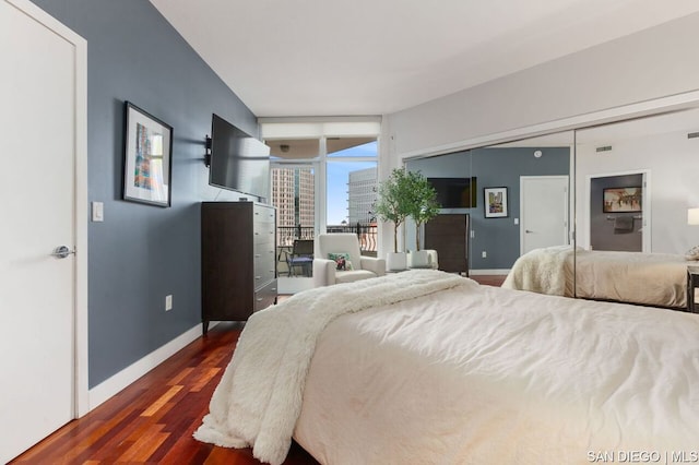 bedroom with dark hardwood / wood-style flooring