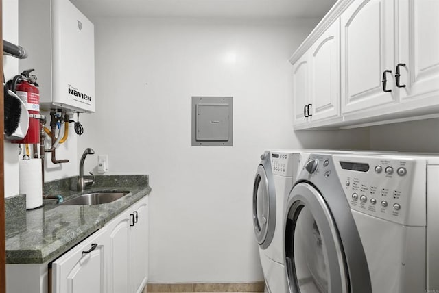 washroom featuring water heater, cabinets, sink, independent washer and dryer, and electric panel