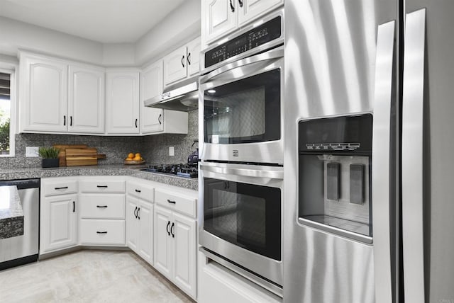 kitchen featuring white cabinets, tasteful backsplash, and appliances with stainless steel finishes