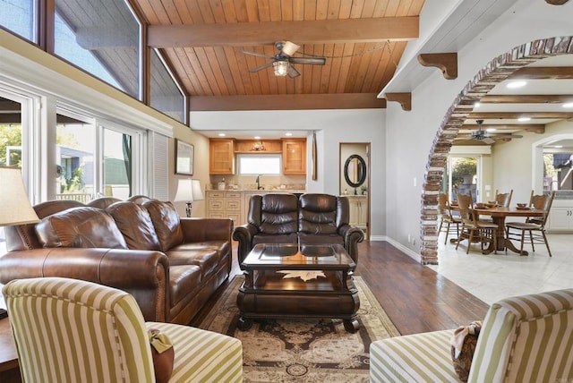 living room with ceiling fan, wooden ceiling, hardwood / wood-style floors, and beamed ceiling