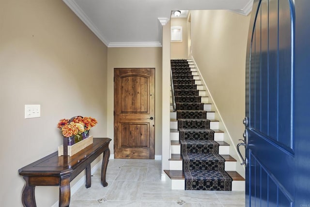 tiled foyer entrance featuring ornamental molding