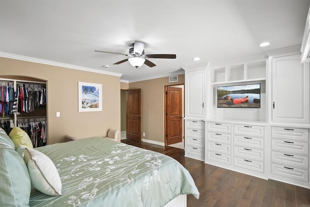 bedroom with ceiling fan, dark wood-type flooring, a closet, and crown molding