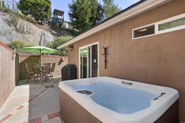 view of patio / terrace with a hot tub