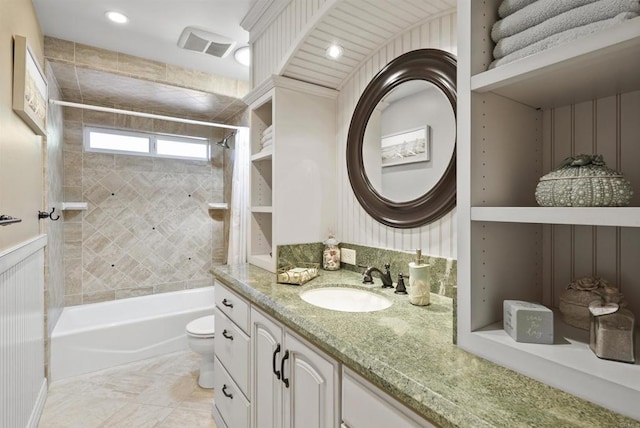 full bathroom featuring toilet, vanity, and tiled shower / bath combo