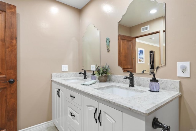 bathroom with crown molding and vanity