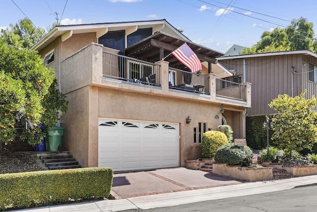 view of front facade with a garage and a balcony