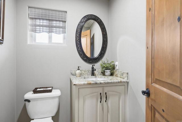 bathroom with toilet and vanity