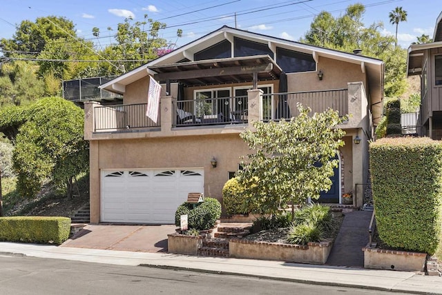 view of front facade with a garage and a balcony