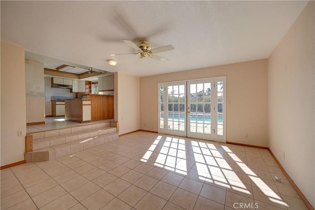 unfurnished living room featuring ceiling fan and light tile patterned floors