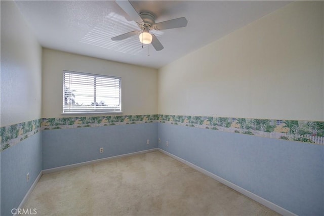 carpeted empty room featuring ceiling fan