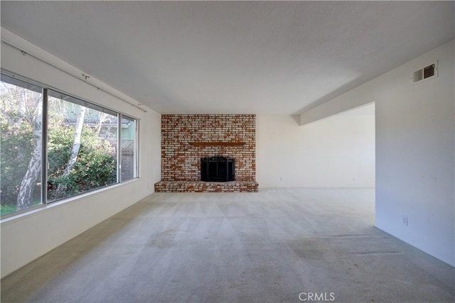 carpeted living room featuring a brick fireplace