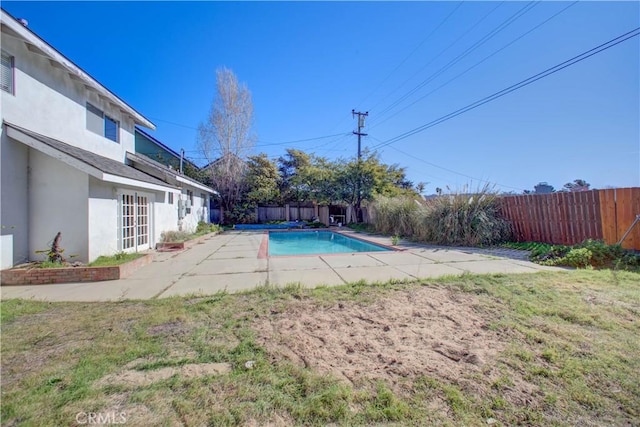 view of swimming pool with a patio area and a lawn