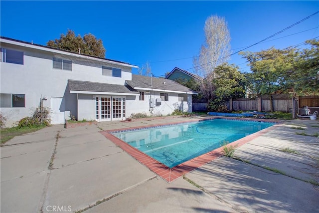 view of pool featuring french doors and a patio