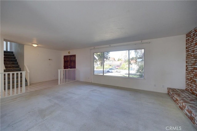 unfurnished living room with light carpet