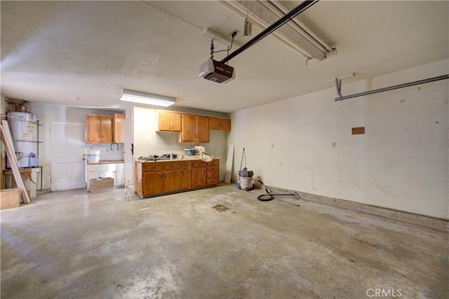 garage with a garage door opener and strapped water heater