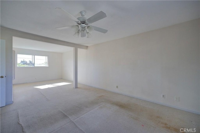 empty room featuring light carpet and ceiling fan