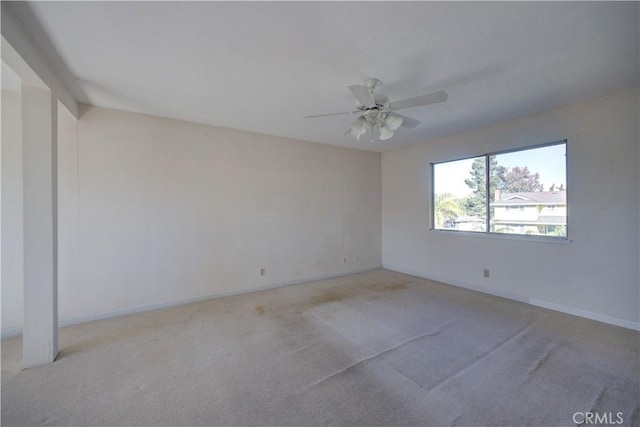 empty room with ceiling fan and light carpet