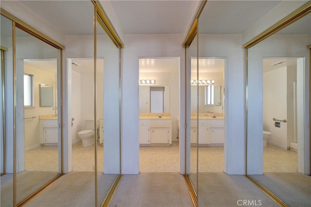 bathroom with sink, toilet, and french doors