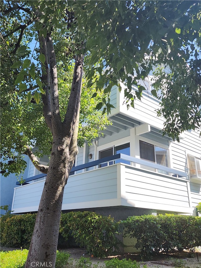 view of side of home featuring a balcony