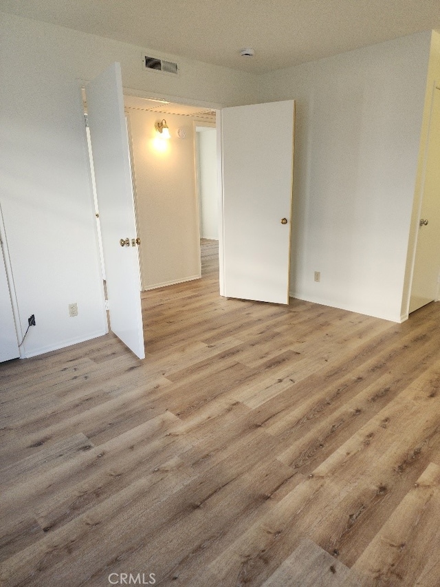 spare room with light hardwood / wood-style flooring