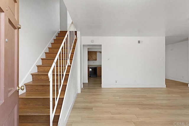 stairs featuring wine cooler and hardwood / wood-style flooring