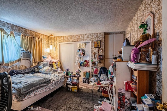 bedroom with carpet floors and a textured ceiling