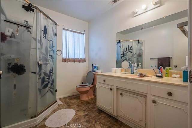 bathroom featuring toilet, an enclosed shower, and vanity