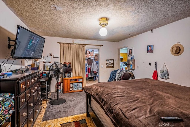 bedroom featuring carpet floors, a closet, and a textured ceiling