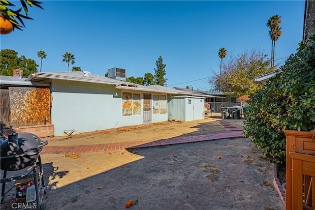 exterior space with central AC, a storage shed, and a patio