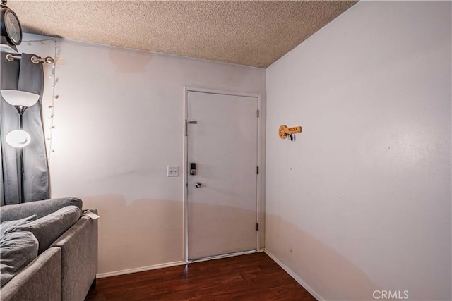 entryway featuring a textured ceiling and dark hardwood / wood-style flooring