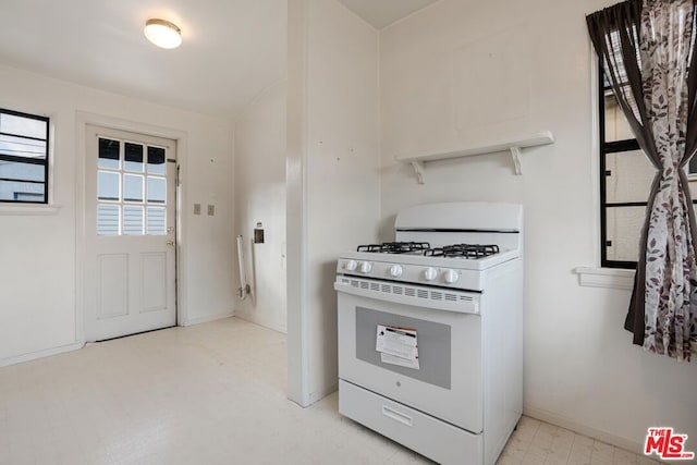 kitchen featuring white range with gas cooktop