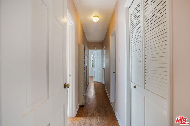 corridor featuring dark hardwood / wood-style floors