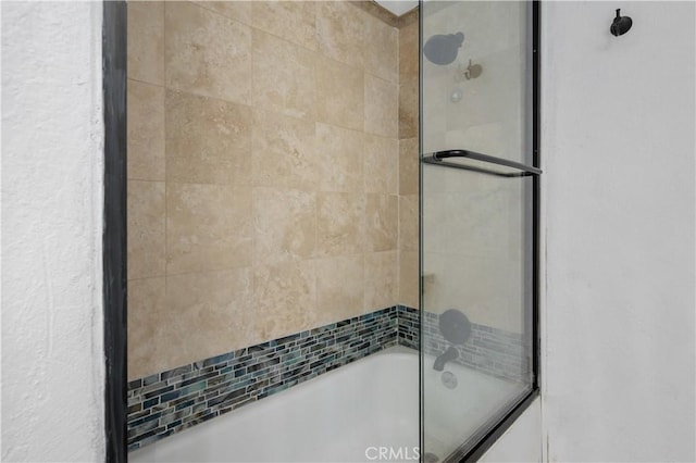 bathroom featuring shower / bath combination with glass door