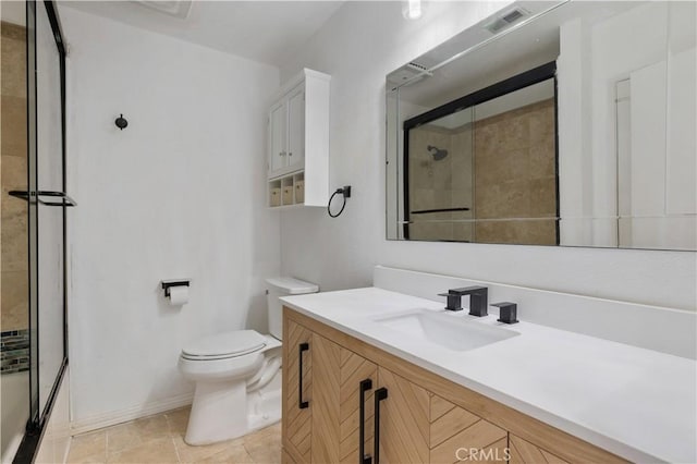 bathroom with toilet, vanity, and tile patterned flooring