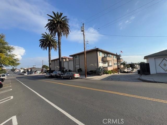 view of street with curbs, sidewalks, and a residential view