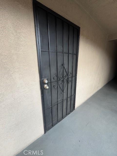 doorway to property featuring stucco siding