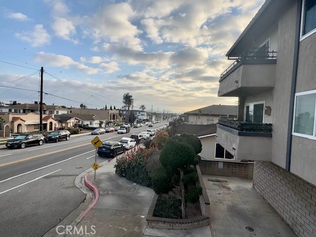 view of road featuring curbs, sidewalks, and a residential view