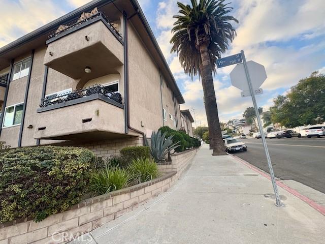 785 W 19th St Unit 12B, San Pedro, CA 90731 - view of side of property featuring stucco siding and a balcony