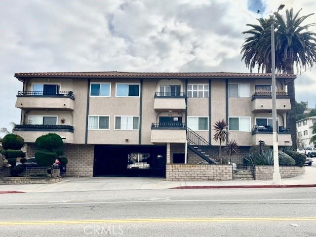 785 W 19th St Unit 12B, San Pedro, CA 90731 - view of property featuring an attached garage and concrete driveway