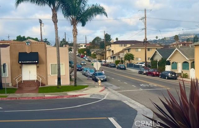 view of street featuring a residential view, curbs, and sidewalks