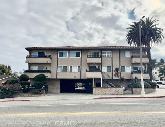 785 W 19th St Unit 12B, San Pedro, CA 90731 - view of property featuring a garage, stairs, and concrete driveway