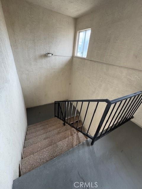 stairway featuring concrete floors