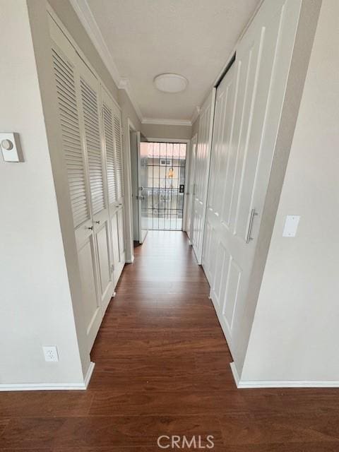 hall featuring crown molding and dark hardwood / wood-style floors